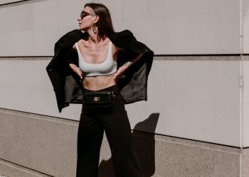 a woman in a crop top and wide legged pants