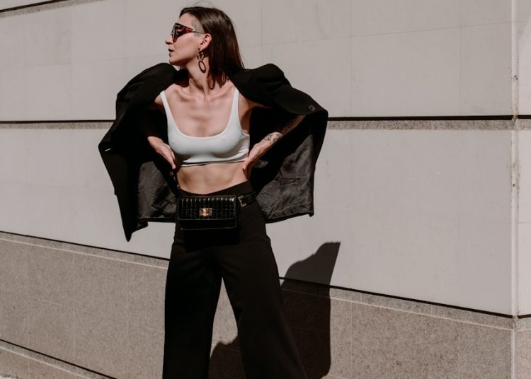 a woman in a crop top and wide legged pants