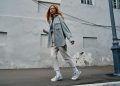 a woman with red hair walking down the street