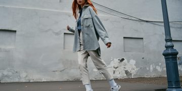 a woman with red hair walking down the street