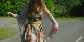 woman in floral dress on road