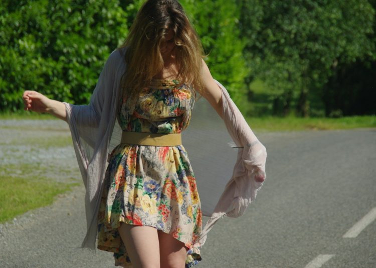 woman in floral dress on road