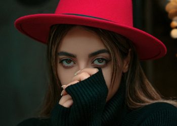 a woman wearing a red hat and black sweater