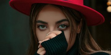 a woman wearing a red hat and black sweater