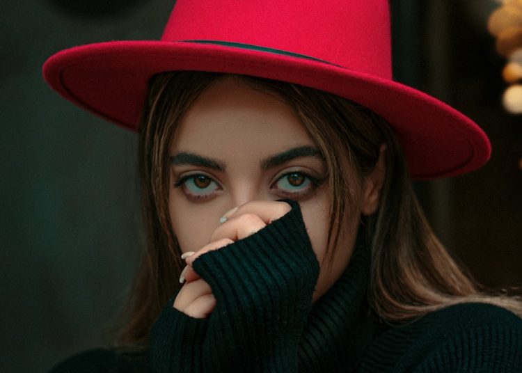 a woman wearing a red hat and black sweater